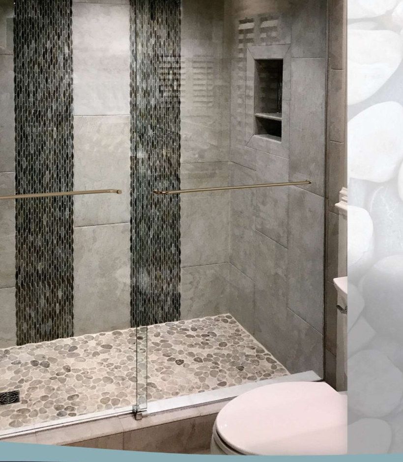 Custom sliding glass shower enclosure with brushed hardware in the Jackson, MS metro